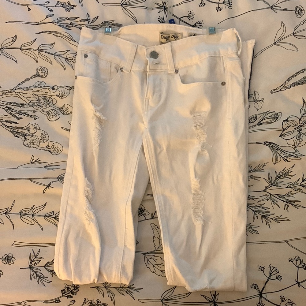 White ripped skinny jeans with navy strip on bottom